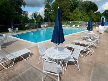 Private swimming pool with chairs at McDonogh Village Apartments & Townhomes, Randallstown, Maryland, 21133